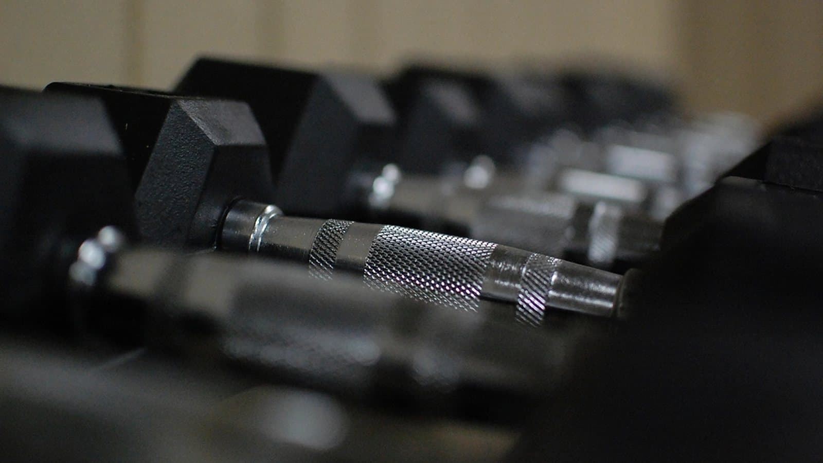 Dumbbell rack on a busy gym floor, the traffic a vending machine should sit beside
